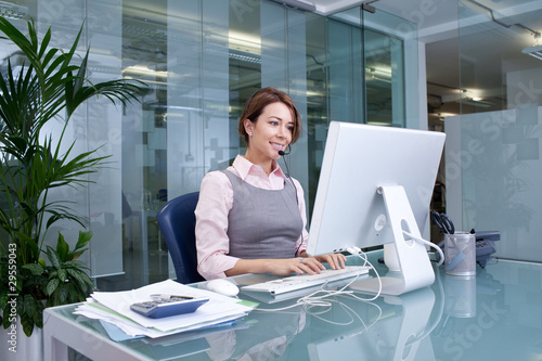 Photo: Customer service representative wearing headset Customer service representative wearing headset