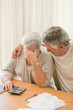 Sad mature couple calculating their domestic bills