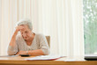 Retired woman calculating her domestic bills