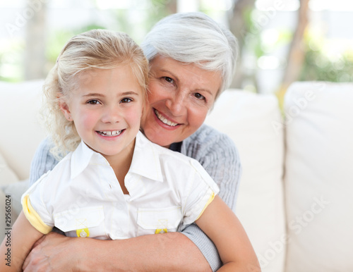 Photo: Lovely little girl with her grandmother looking at the camera Lovely little girl with her grandmother looking at the camera