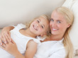 Beautiful woman lying down with her daughter Beautiful woman lying down with her daughter