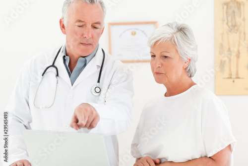Photo: Doctor and his patient looking at the laptop Doctor and his patient looking at the laptop