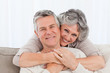 Mature couple looking at the camera at home Mature couple looking at the camera at home