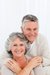 Mature couple looking at the camera at home Mature couple looking at the camera at home