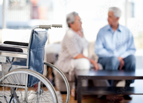 Photo: Lovely retired couple talking on the sofa Lovely retired couple talking on the sofa