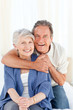 Senior couple hugging on their bed Senior couple hugging on their bed
