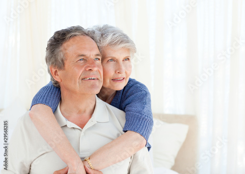 Photo: Senior couple hugging on their bed Senior couple hugging on their bed