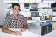 Photo : Happy owner of a computer repair store Happy owner of a computer repair store