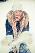 Happy young woman plays with a snow