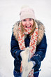 Happy young woman plays with a snow