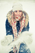 Happy young woman plays with a snow
