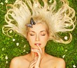 Young woman relaxing on a meadow..