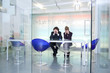 Two sad businesspeople in conference room