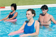 Active people doing aqua gym in a pool