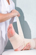 Applying a bandage to a leg