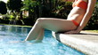 Young woman's legs in the swimming pool