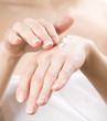 Female applying moisturizer to her Hands Female applying moisturizer to her Hands