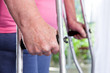 Hands of an elder woman with crutches
