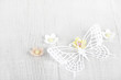paper butterfly and three sugar blossom flowers on white old tab paper butterfly and three sugar blossom flowers on white old tab