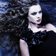 Beautiful girl with flying hair. Girl with evening make-up and c