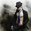 Beautiful young man posing on grunge background