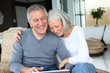 Happy senior couple connected on internet at home Happy senior couple connected on internet at home