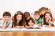 Kids crowd reading book