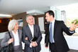 Senior couple visiting modern house with real-estate agent