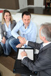 Couple shaking hand to real-estate agent