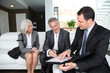 Senior couple signing financial contract for property purchase
