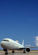 Airplane on airport. Blue sky background.