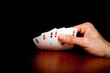 Hand revealing four aces