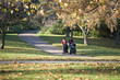 Two mothers pushing their buggies in the park