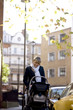 A mother pushing a buggy in the street