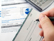Man filling out cheque on the investment papers Man filling out cheque on the investment papers