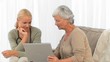 Patient showing something on her laptop to her nurse