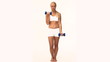 Blond woman doing exercises against a white background