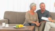 Mature couple answering to a commercial woman