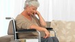 Elderly woman in a wheelchair thinking