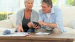 Mature couple calculating their domestic bills