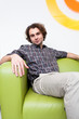 Young man sitting on couch in office