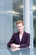 Confident businesswoman sitting at conference table