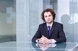Serious businessman sitting at conference table