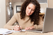 Photo: Woman paying bills Woman paying bills