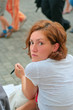 The serious girl with the handle sitting on a bench