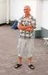 The smiling man in a checkered shirt in glasses