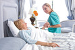 Photo: Taking care of an old woman Taking care of an old woman