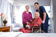 Elder couple with an assistant in a hospital