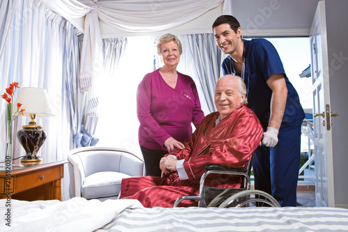 Photo: Elder couple with an assistant in a hospital Elder couple with an assistant in a hospital