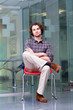 Serious man sitting on chair in office